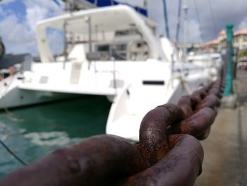 Close-up of hand on boat moored at harbor