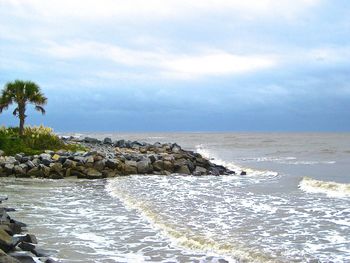 Scenic view of sea against cloudy sky