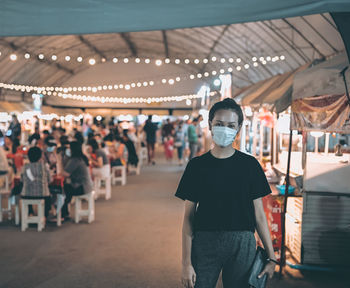 Front view of young woman tour in night food market travel and recreation concept