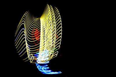 Close-up of illuminated light over black background