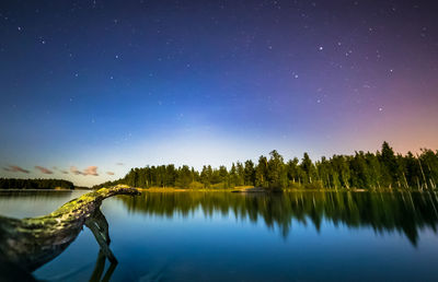 Scenic view of lake against sky at night