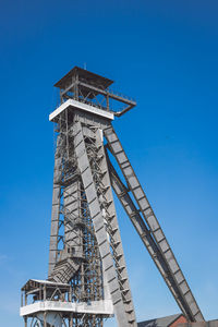 Low angle view of tower against clear blue sky