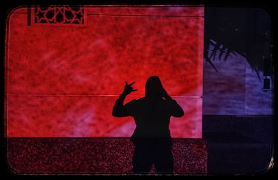 Silhouette of person with red umbrella