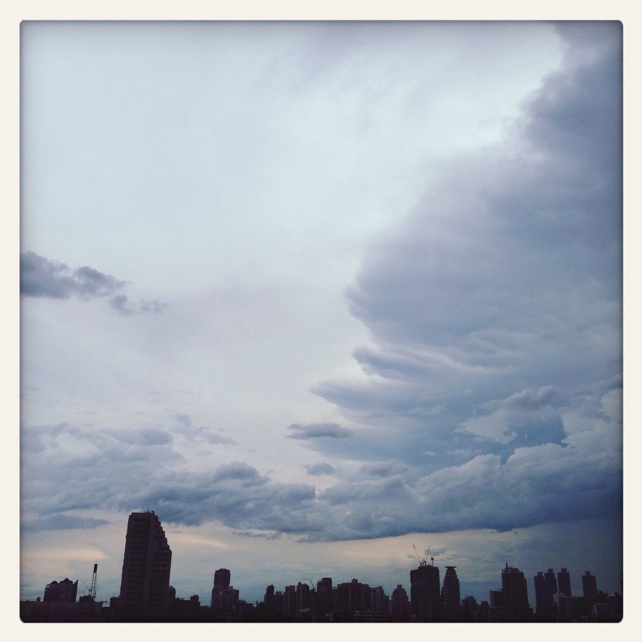 building exterior, city, sky, architecture, built structure, skyscraper, cloud - sky, cityscape, transfer print, urban skyline, auto post production filter, silhouette, cloud, cloudy, skyline, tall - high, weather, tower, outdoors, no people