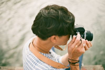 High angle view of man photographing through camera