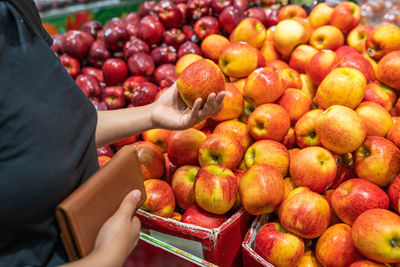 Midsection of man holding fruit