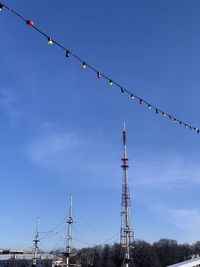 Low angle view of telephone pole against blue sky