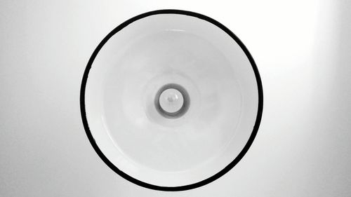 Directly above shot of spiral object over white background