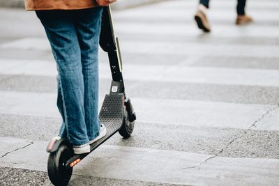 Low section of woman walking on footpath