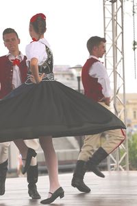 Rear view of people dancing in park