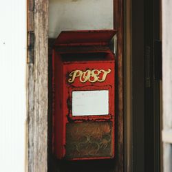 Close-up of red mailbox on door