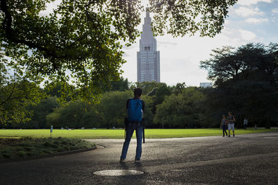 Rear view of man and woman walking in park