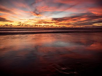 Scenic view of sea against romantic sky at sunset