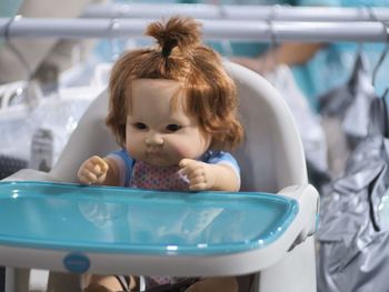 Close-up of cute doll on high chair