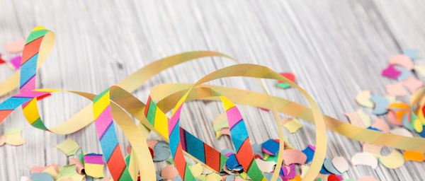 Close-up of multi colored confetti on table 