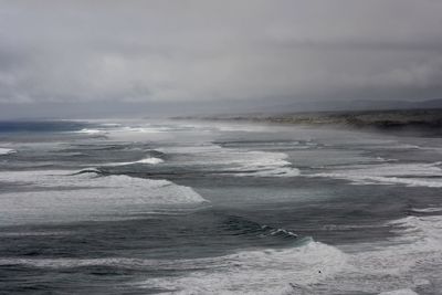 Scenic view of sea against cloudy sky