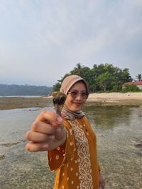 Low angle view of woman holding umbrella