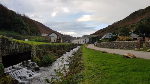 Panoramic shot of road amidst buildings against sky