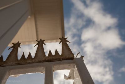 Low angle view of fence against sky