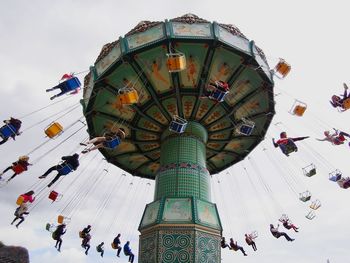 Low angle view of amusement park ride against sky