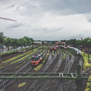 Train on railroad tracks in city against sky