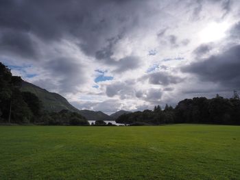 Scenic view of landscape against cloudy sky