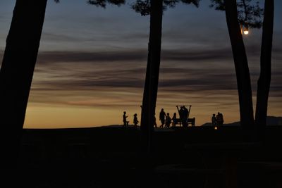 Silhouette people against sky during sunset