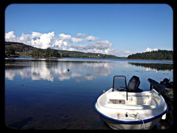 Scenic view of calm lake against sky