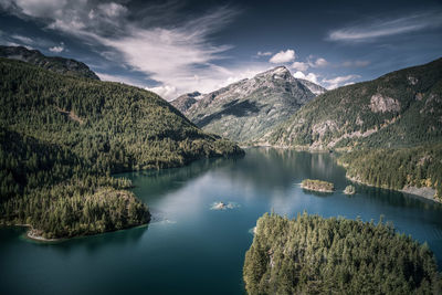 High angle view of lake and mountains against sky