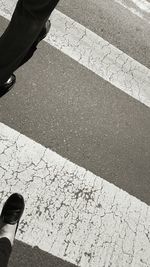 Low section of man standing on cobblestone street