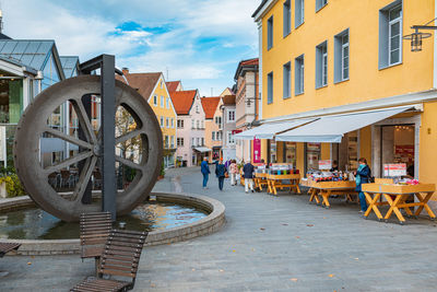 People on street amidst buildings in town