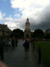 People walking on footpath in city