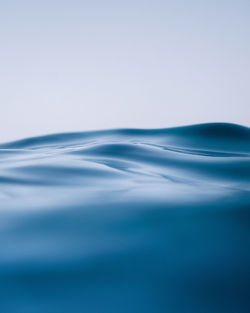 Close-up of rippled water against blue background