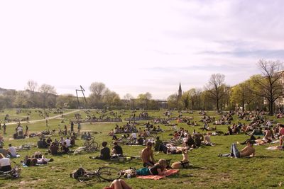 Group of people relaxing on field