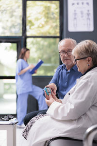 Female doctor examining patient in office