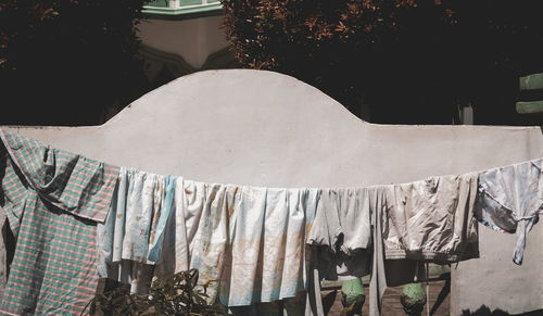 Close-up of clothes drying against white wall