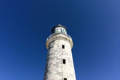 Low angle view of lighthouse against clear blue sky