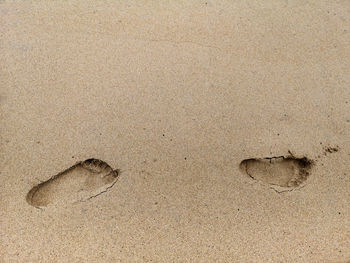 High angle view of footprints on sand