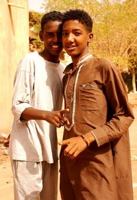 Portrait of smiling friends standing outdoors