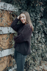 Portrait of a smiling young woman standing outdoors