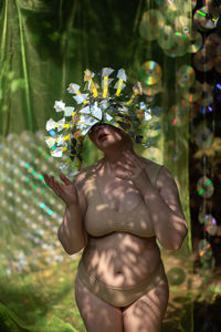 Portrait a woman in a reflective mask in a beige bikini on a cd / dvd case of scenery in the forest