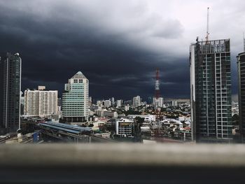 City skyline against cloudy sky