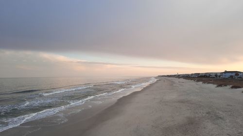 Scenic view of beach against sky during sunset