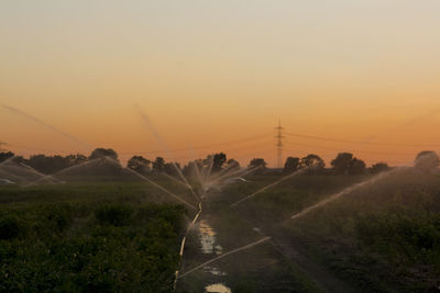 Scenic view of field against sky at dusk