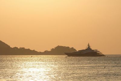 Scenic view of sea against clear sky during sunset