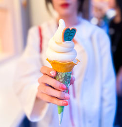 Midsection of woman holding ice cream