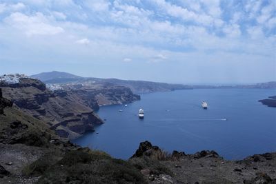 High angle view of bay and rocks against sky