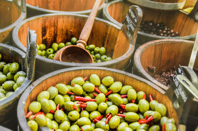 High angle view of different olives in barrels at a market