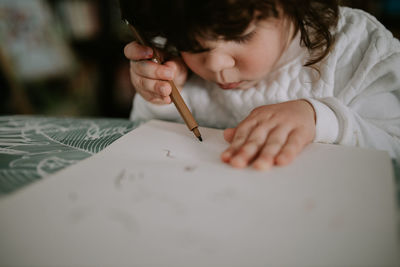 Little girl drawing at home