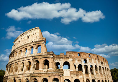 Rome, italy. arches archictecture of colosseum  - colosseo - exterior with blue sky background